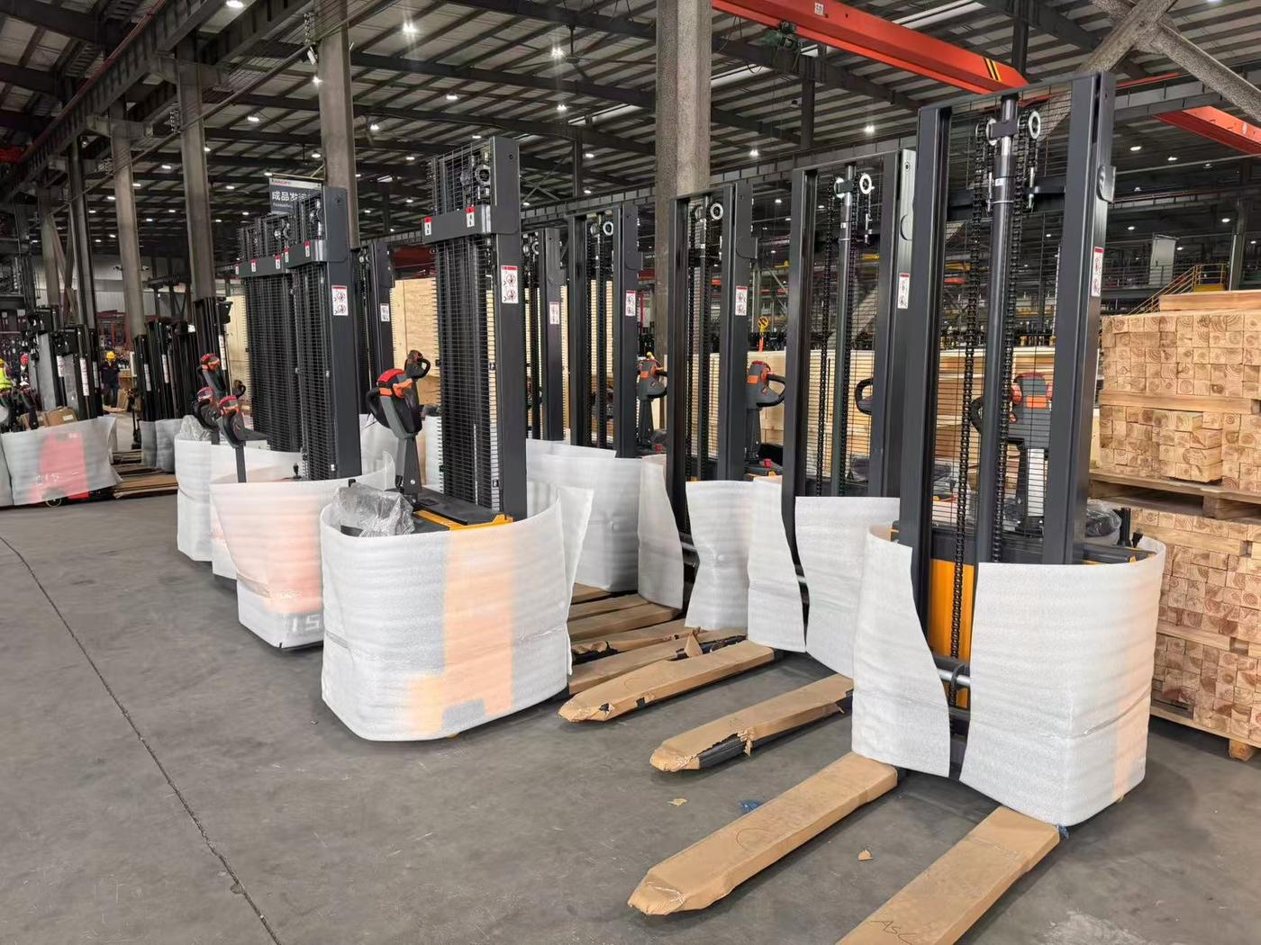 Accelift electric stackers wrapped in foam and lined up for loading