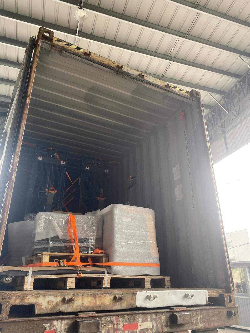 Mixed load of stackers and pallet trucks strapped at the door end of a 40HQ